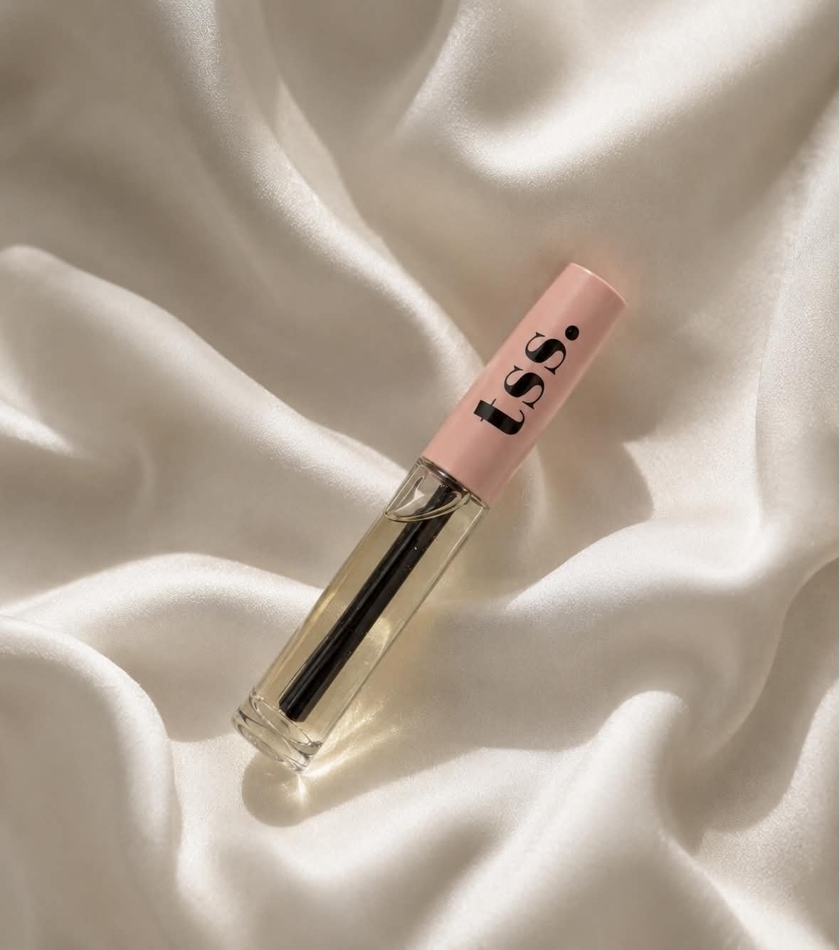Lash and brow hydrating serum tube on ivory satin